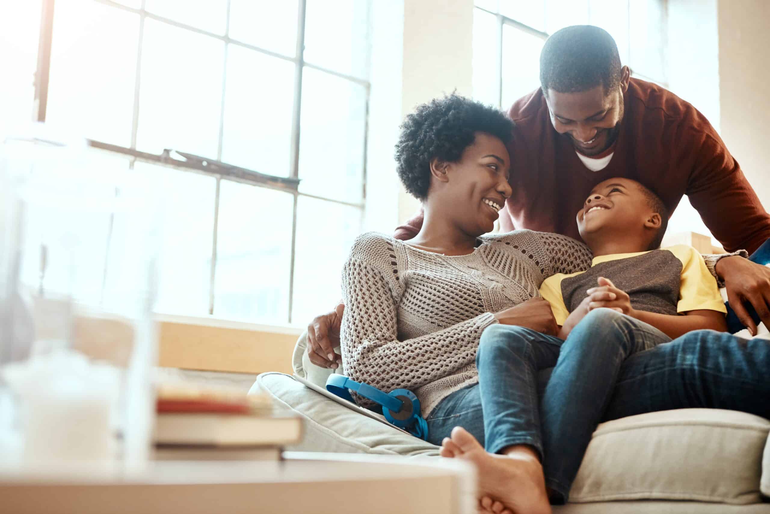 Black,Family,,Happy,And,Relax,On,Sofa,With,Boy,And